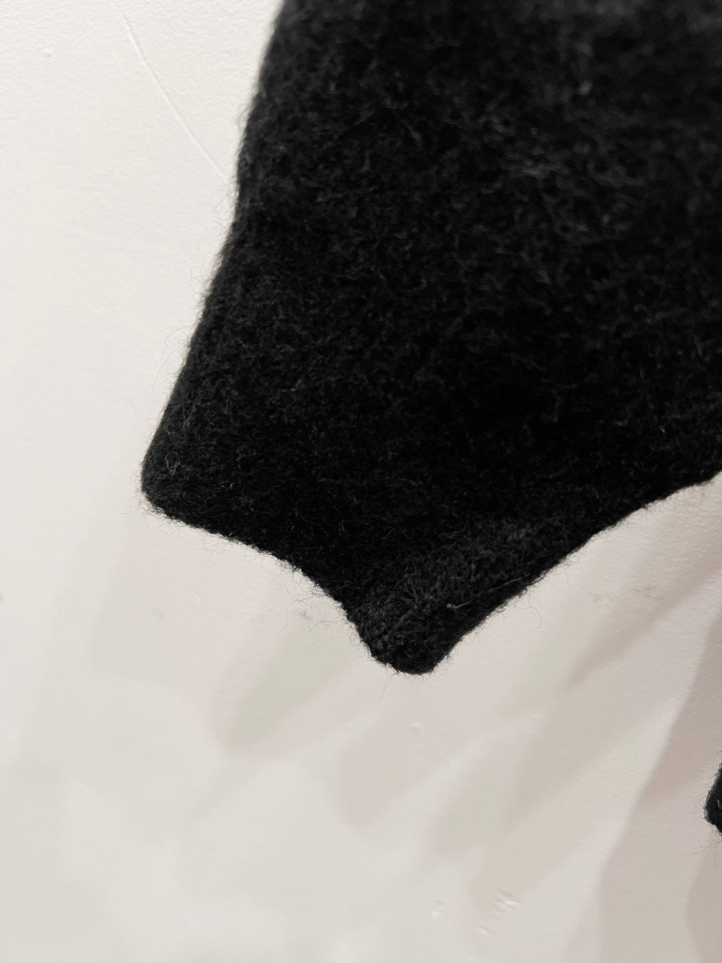 Louis Vuitton sweater hem, dark knit fabric with textured finish
