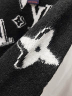 Black knit sweater with white star and LV-style monogram intarsia