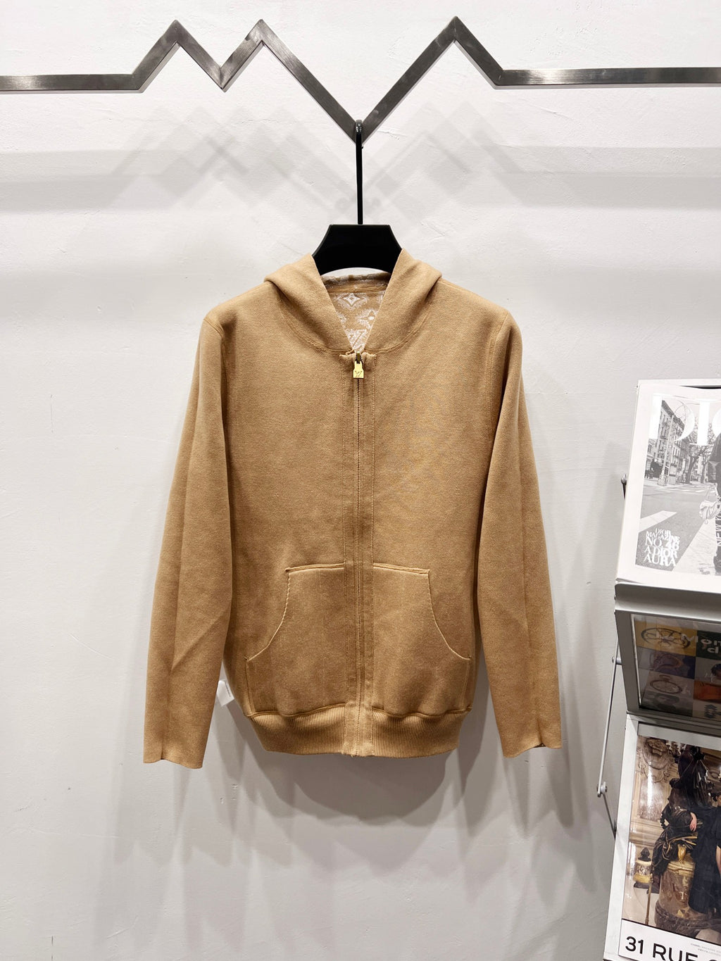 Tan zip-up hoodie front with hood, kangaroo pocket, and small chest detail