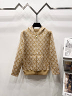 Tan zip-up hoodie with allover monogram pattern and beige hood lining
