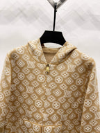 Tan monogram zip-up hoodie close-up with gold zipper and hood drawstring