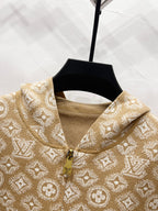 Tan monogram zip-up hoodie collar close-up with gold zipper and knit trim