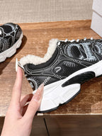 Unisex sneaker with black upper, white graphic design, faux fur collar, lace-up