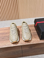 Prada unisex sneakers in light beige, lace-up design with chunky white sole.