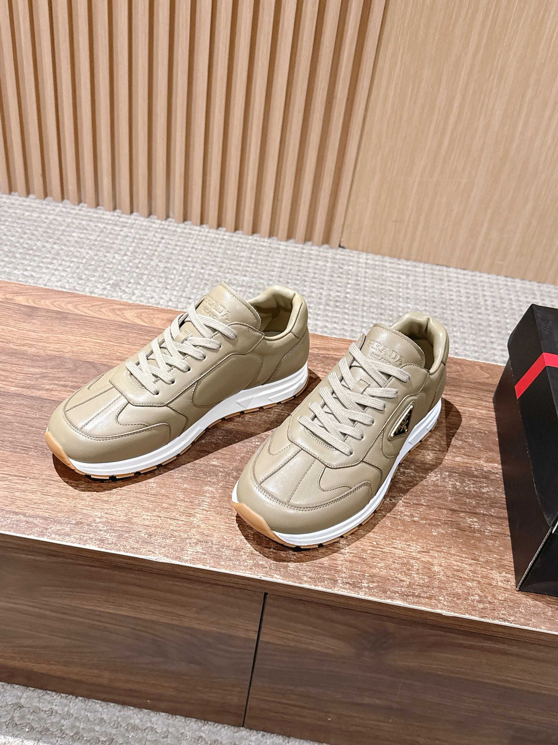 Prada unisex lace-up sneakers in light beige, shown in side-by-side view.