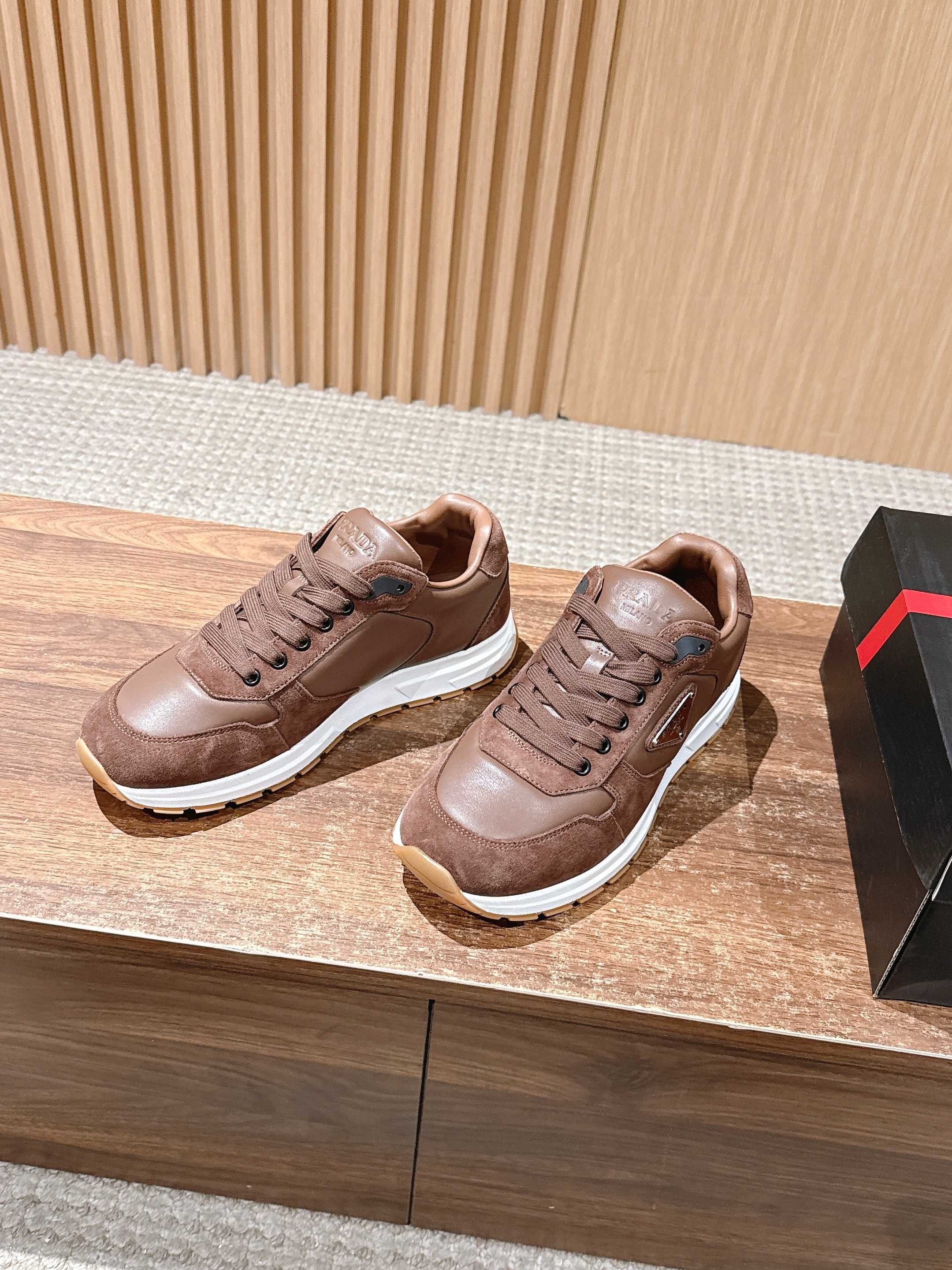 Taupe leather unisex sneakers, lace-up style with white midsoles.