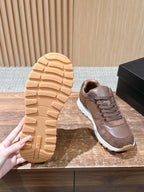 Taupe sneaker outsole with textured tread and white midsole.
