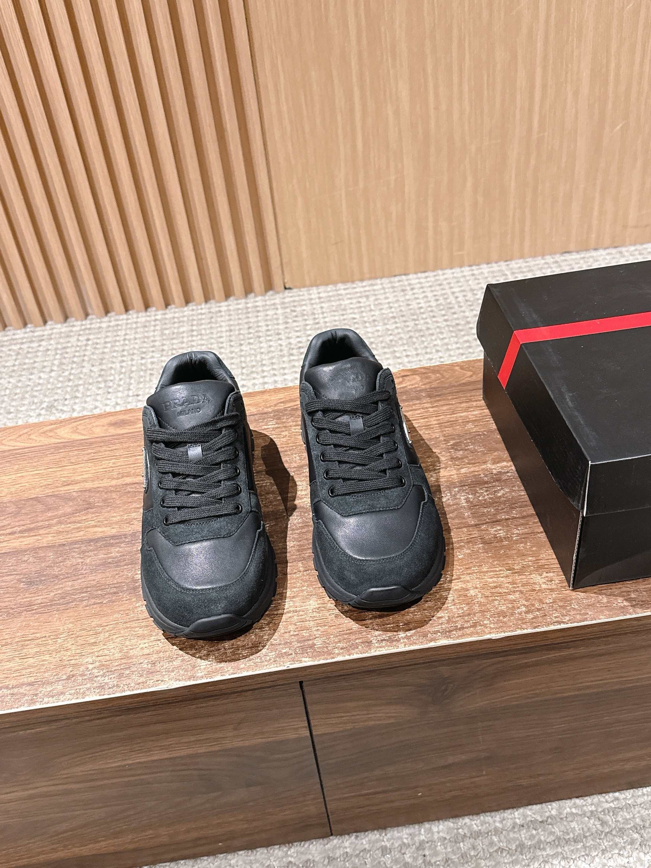Dark unisex sneakers with lace-up front and low-profile rubber sole