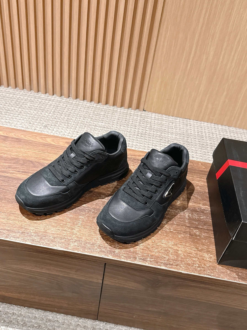 Dark unisex sneakers, lace-up style with textured side panels and rubber sole