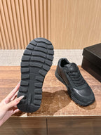 Dark unisex sneaker outsole showing tread pattern and lace-up upper