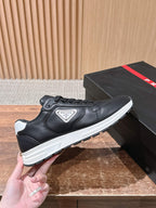 Prada unisex sneakers, black leather lace-up with Prada badge and white sole