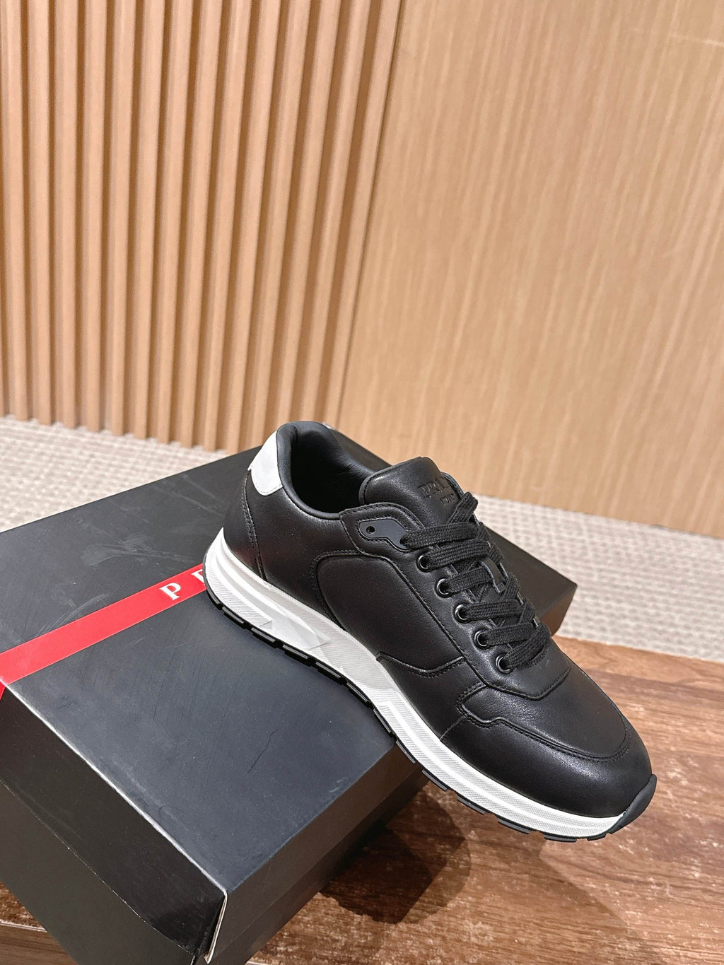 Prada unisex sneakers in black leather, lace-up with white rubber sole