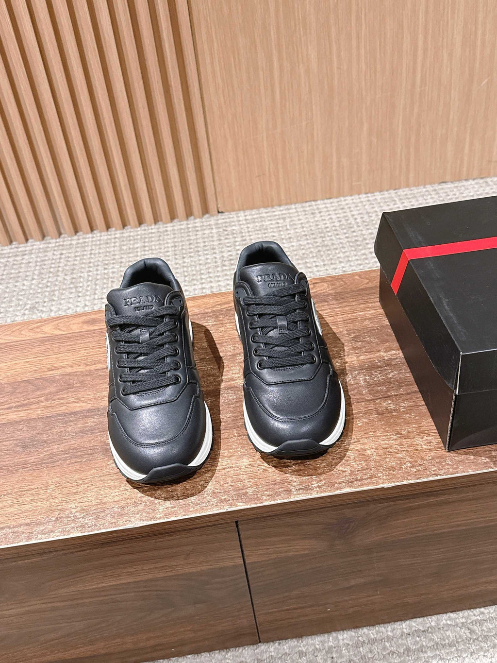 Prada unisex leather sneakers, black with lace-up front and white sole
