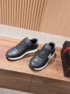 Prada unisex sneakers, black uppers with white midsoles and lace-up design