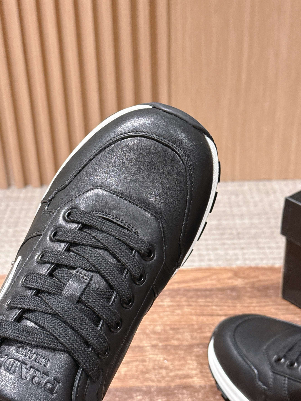 Prada unisex sneakers, black leather upper with laces and textured toe cap