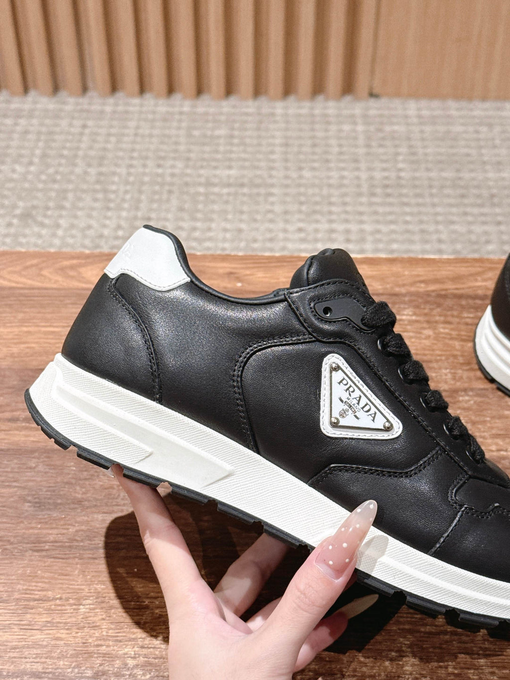Prada unisex sneakers, black leather lace-up with white midsole and side logo