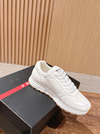 Prada white lace-up sneakers with cream laces and tan rubber sole