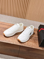 Prada white lace-up sneakers with tan outsole and textured side panels
