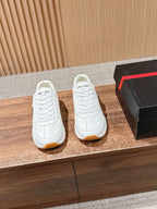 Prada white lace-up sneakers with textured side logo and tan rubber sole