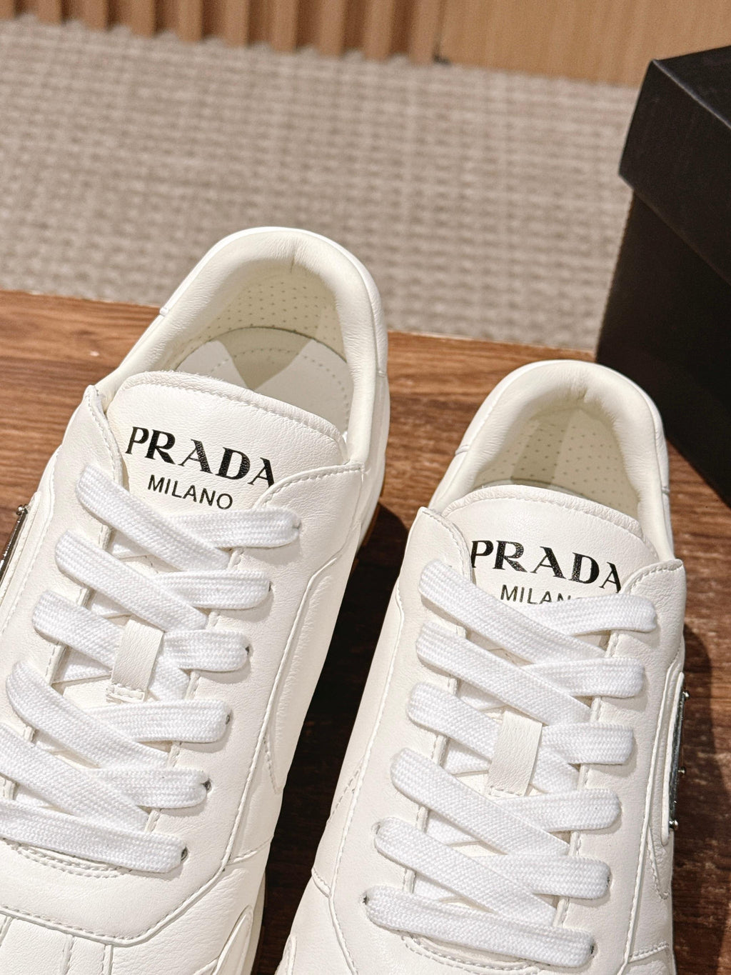 Prada white lace-up sneakers with PRADA MILANO label on the tongue