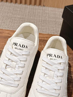 Prada white lace-up sneakers with PRADA MILANO label on the tongue