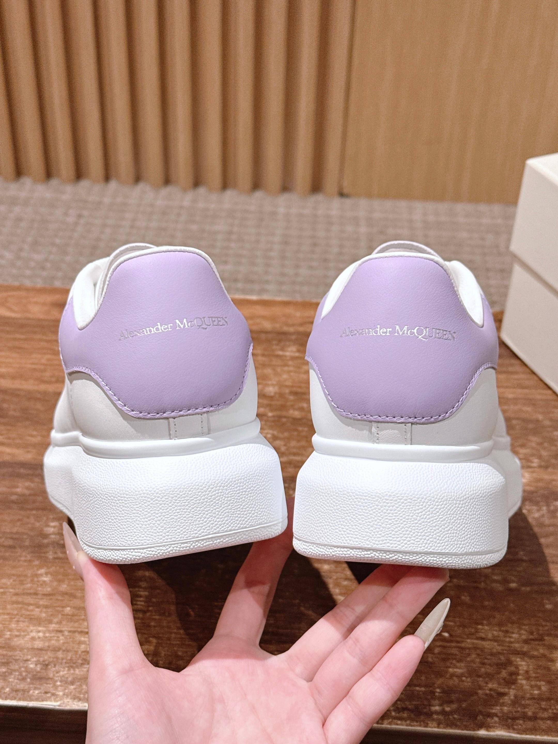 White leather sneakers with lavender inner lining, chunky white sole at heels