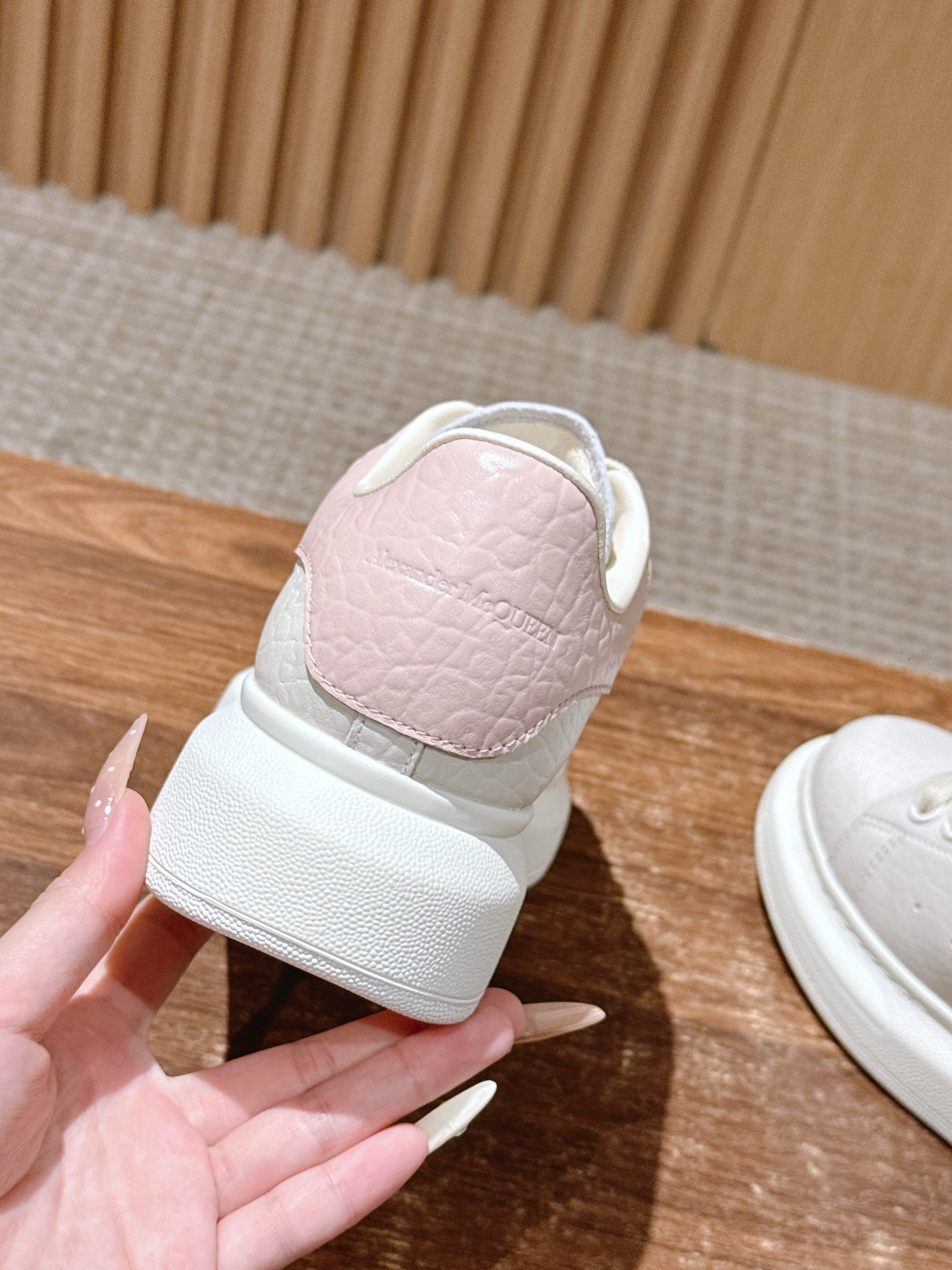 Back view of white leather sneakers on textured sole