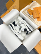 White Louis Vuitton low-top trainer shoes with navy quarter panels and blue striping