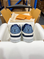 Louis Vuitton trainer sneakers, rear view with navy circular logo on heel and white soles.