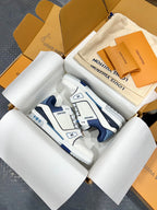 Louis Vuitton trainer sneakers, white and navy with textured panels and LV logo on side.