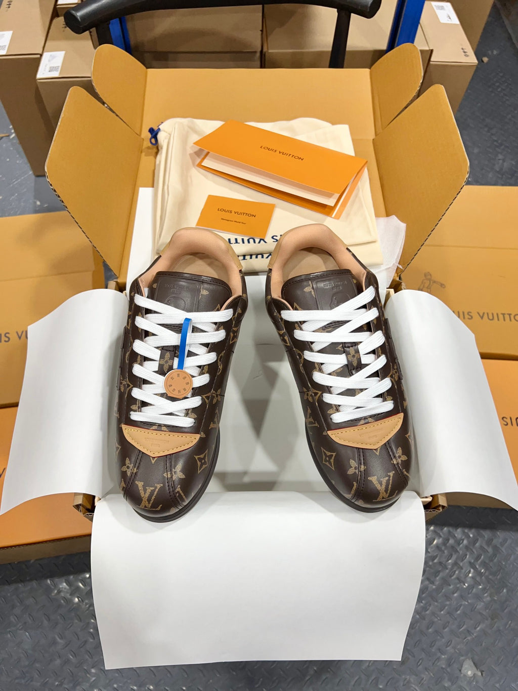 Unisex Louis Vuitton monogram sneakers with white laces and tan heel detail