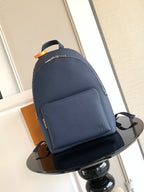 Navy leather backpack with front pocket and adjustable shoulder straps
