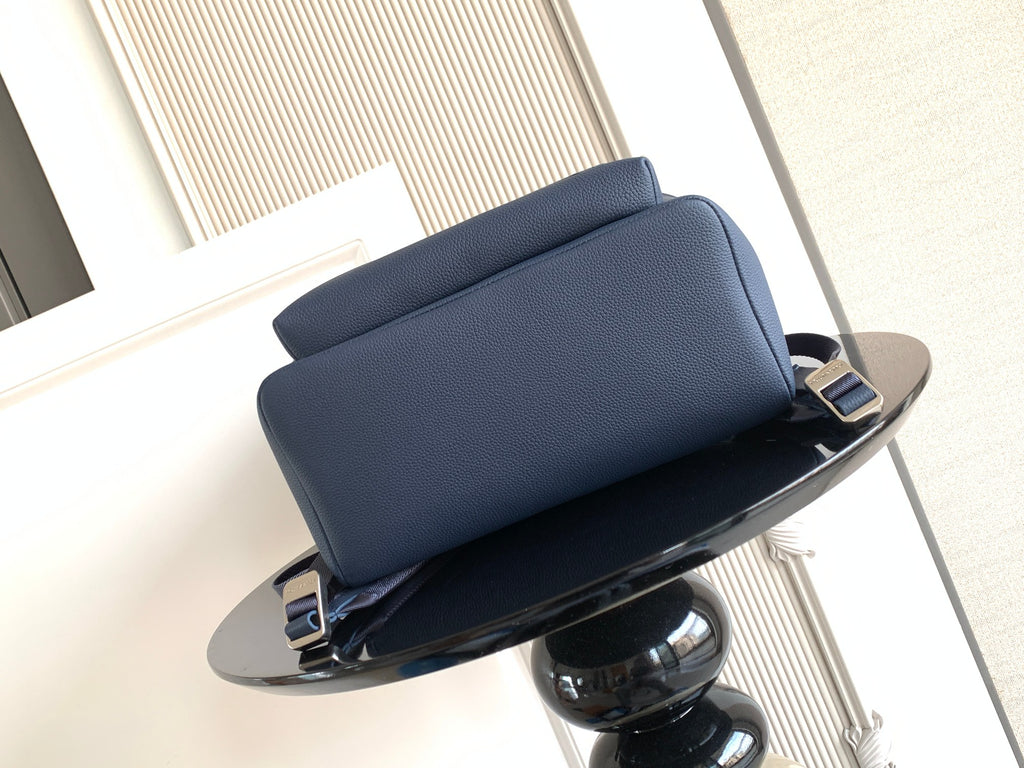 Navy leather backpack back panel with padded straps and top carry handle