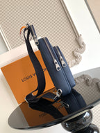 Louis Vuitton blue crossbody bag with dual top zippers and adjustable shoulder strap
