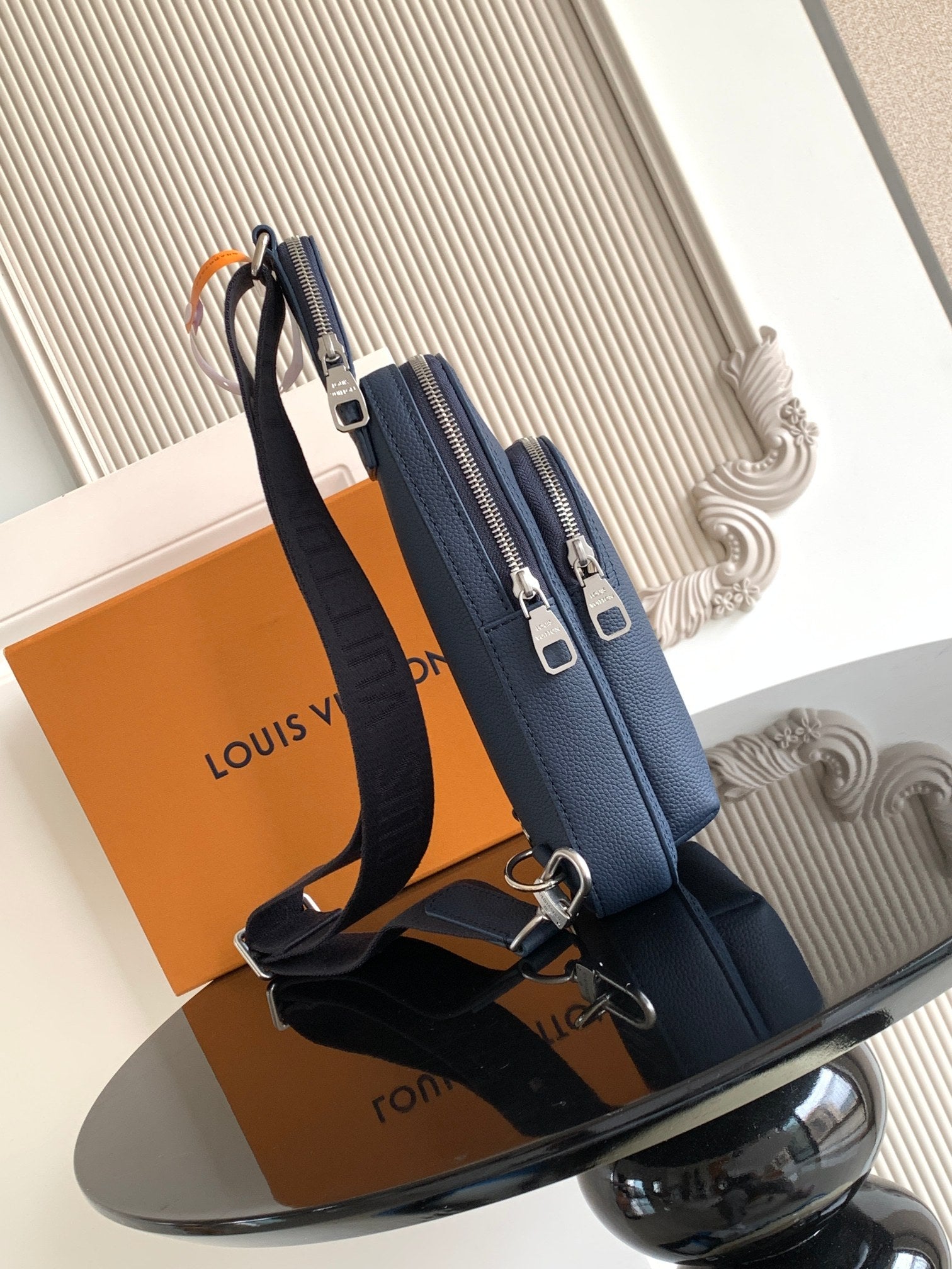 Louis Vuitton blue crossbody bag with dual top zippers and adjustable shoulder strap