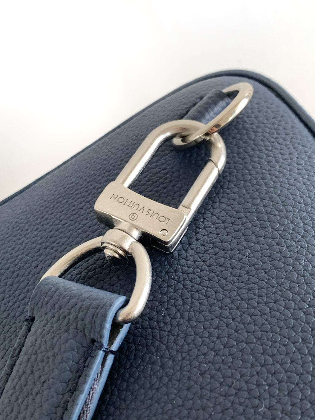 Dark blue leather bag strap with silver D-ring and rectangular padlock-style clasp