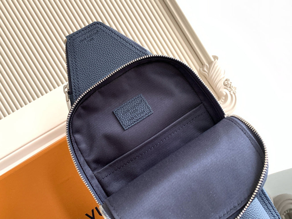 Small crossbody bag interior, dark fabric lining and zipper opening with patch