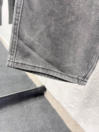 Gray denim pants hem with stitched cuff