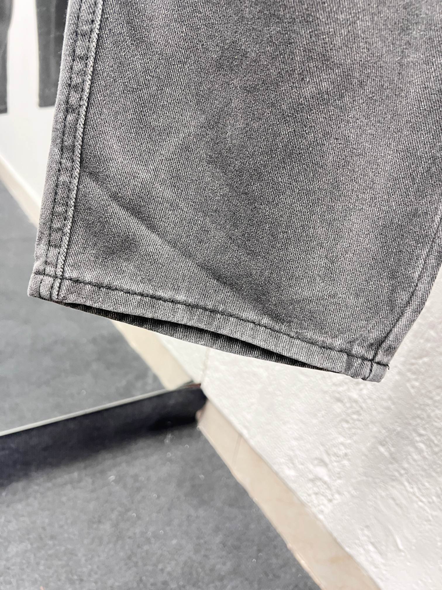 Gray denim pants hem with stitched cuff