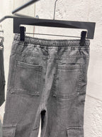 Dark gray denim pants with front pockets, stitched cargo pocket, elastic waist