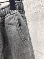 Dark gray denim waistband with elastic and seam detail on cargo pants