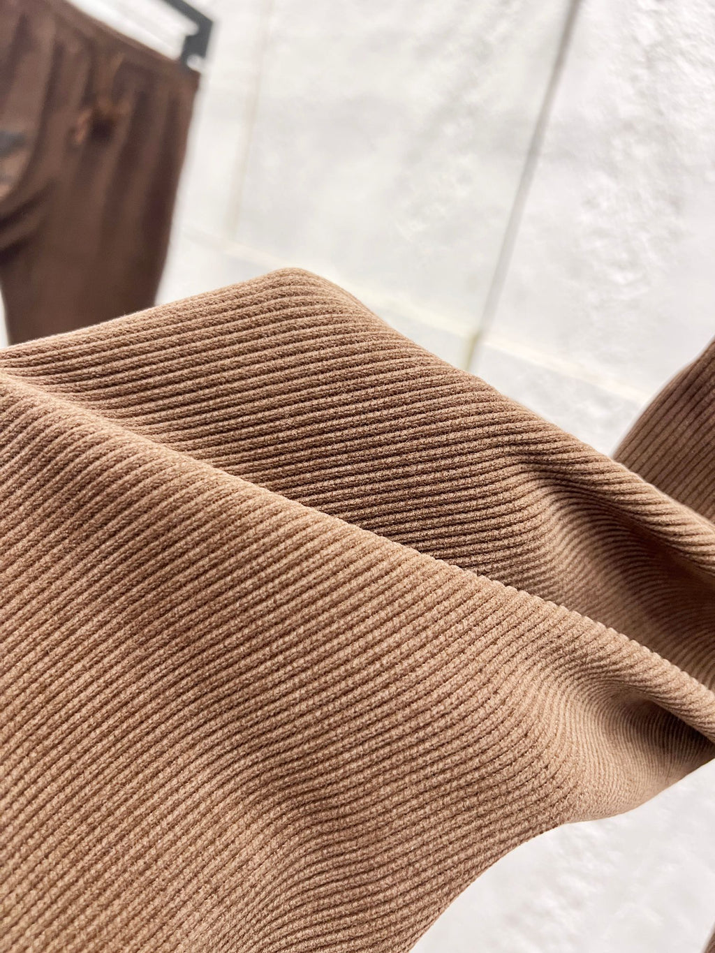 Brown ribbed corduroy fabric texture on pants