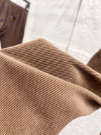 Brown ribbed corduroy fabric texture on pants