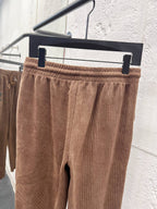 Brown corduroy pants with elastic waistband and drawstring on hanger