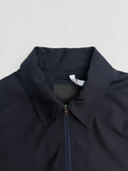 Prada long jacket dark navy with stand collar and centered zipper placket close-up
