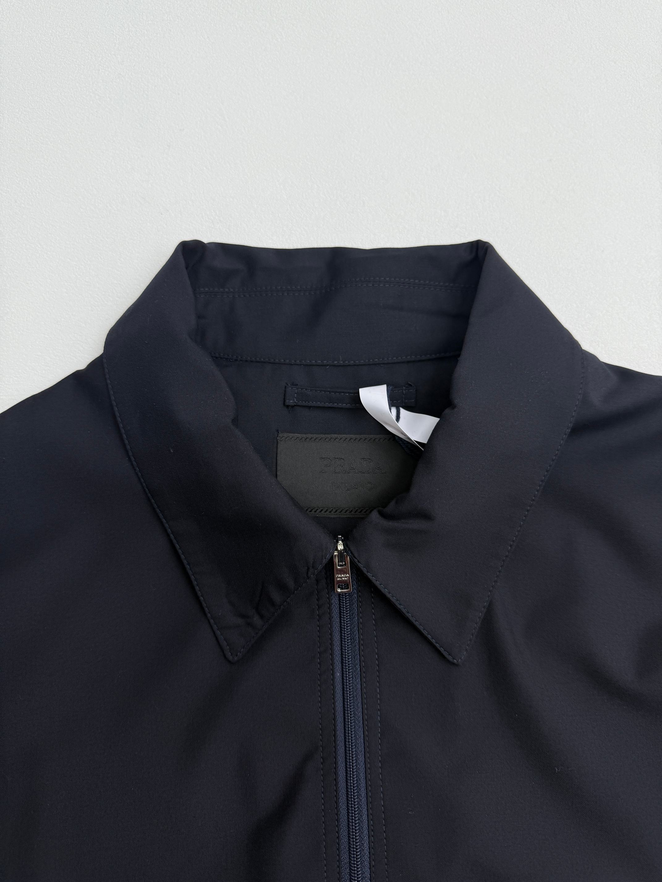 Prada long jacket dark navy with stand collar and centered zipper placket close-up