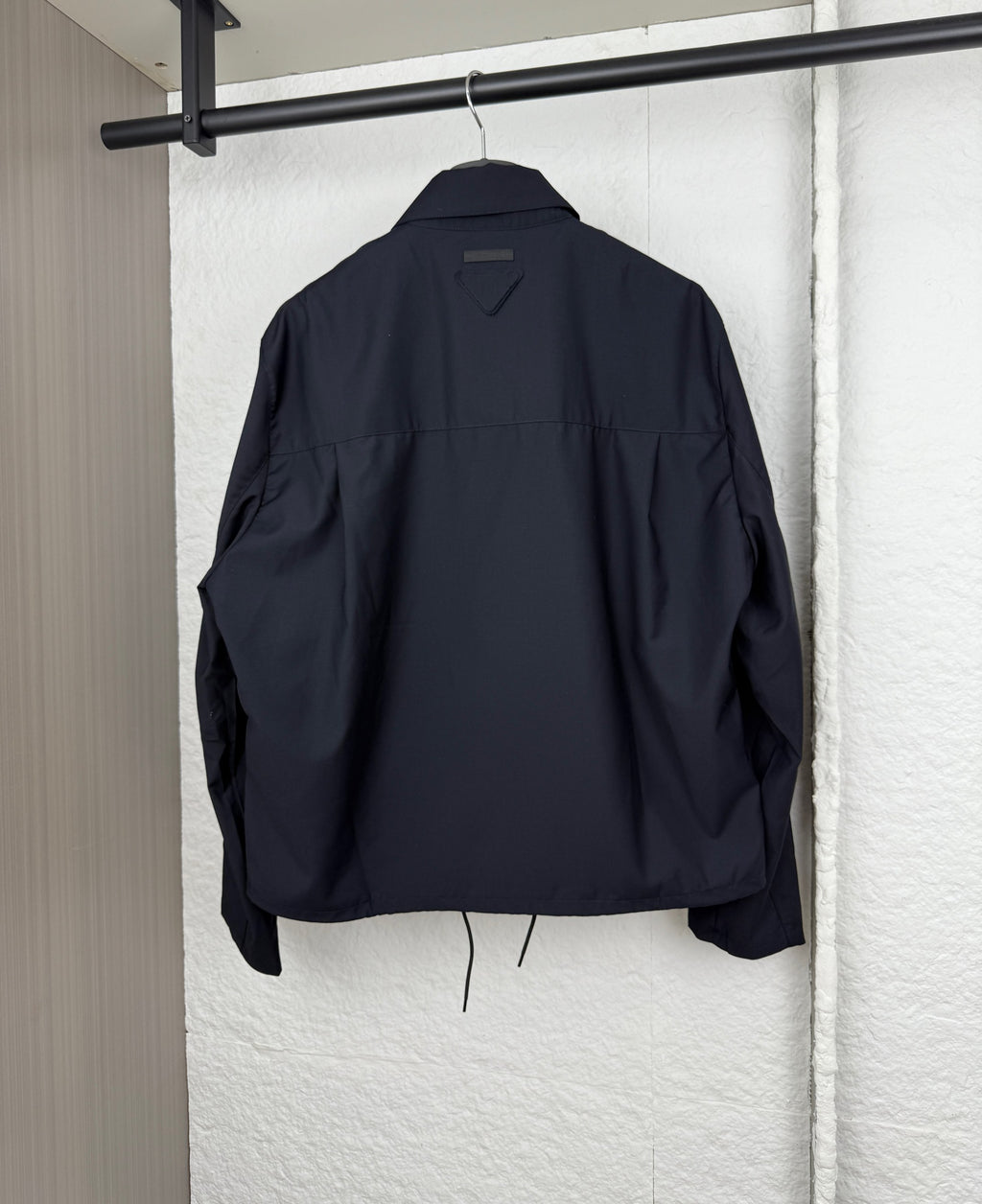 Prada long jacket back view in dark navy with stand collar and drawstring at hem