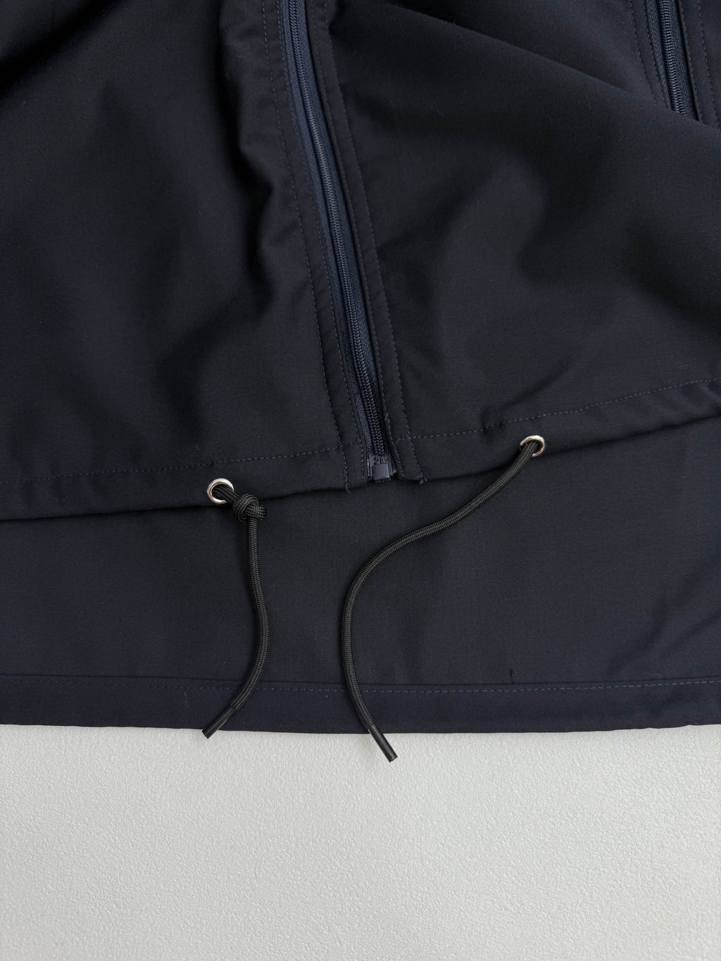 Prada long jacket dark navy with drawstring cord at front hem and zipper pocket panel