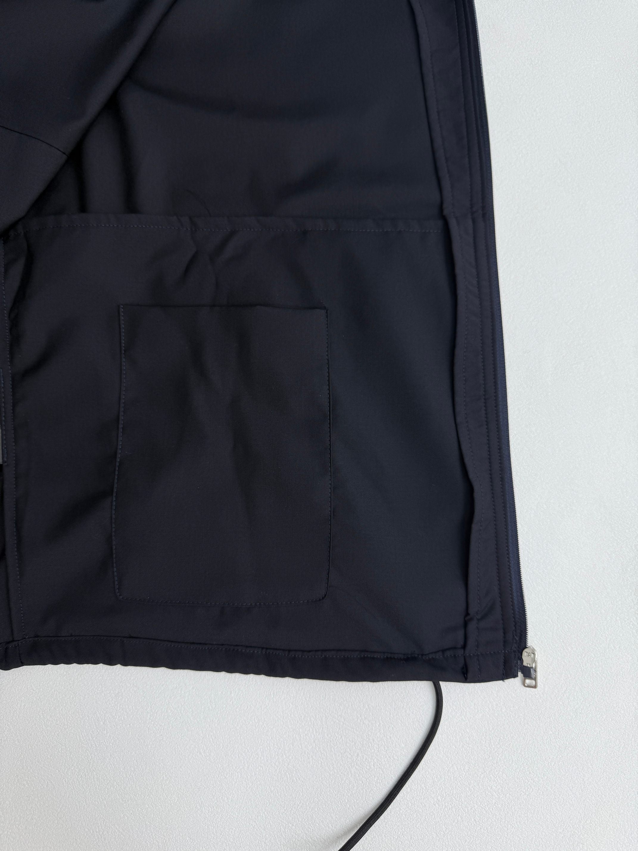 Prada long jacket dark navy with interior pocket panel and seam lines close-up
