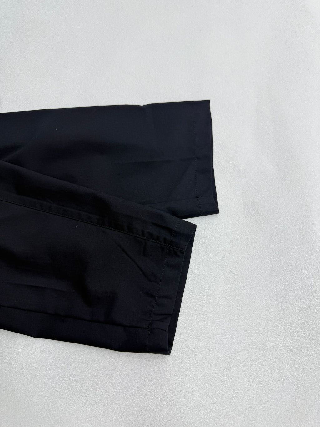 Prada long jacket dark navy lower sleeve and hem with layered stitching close-up